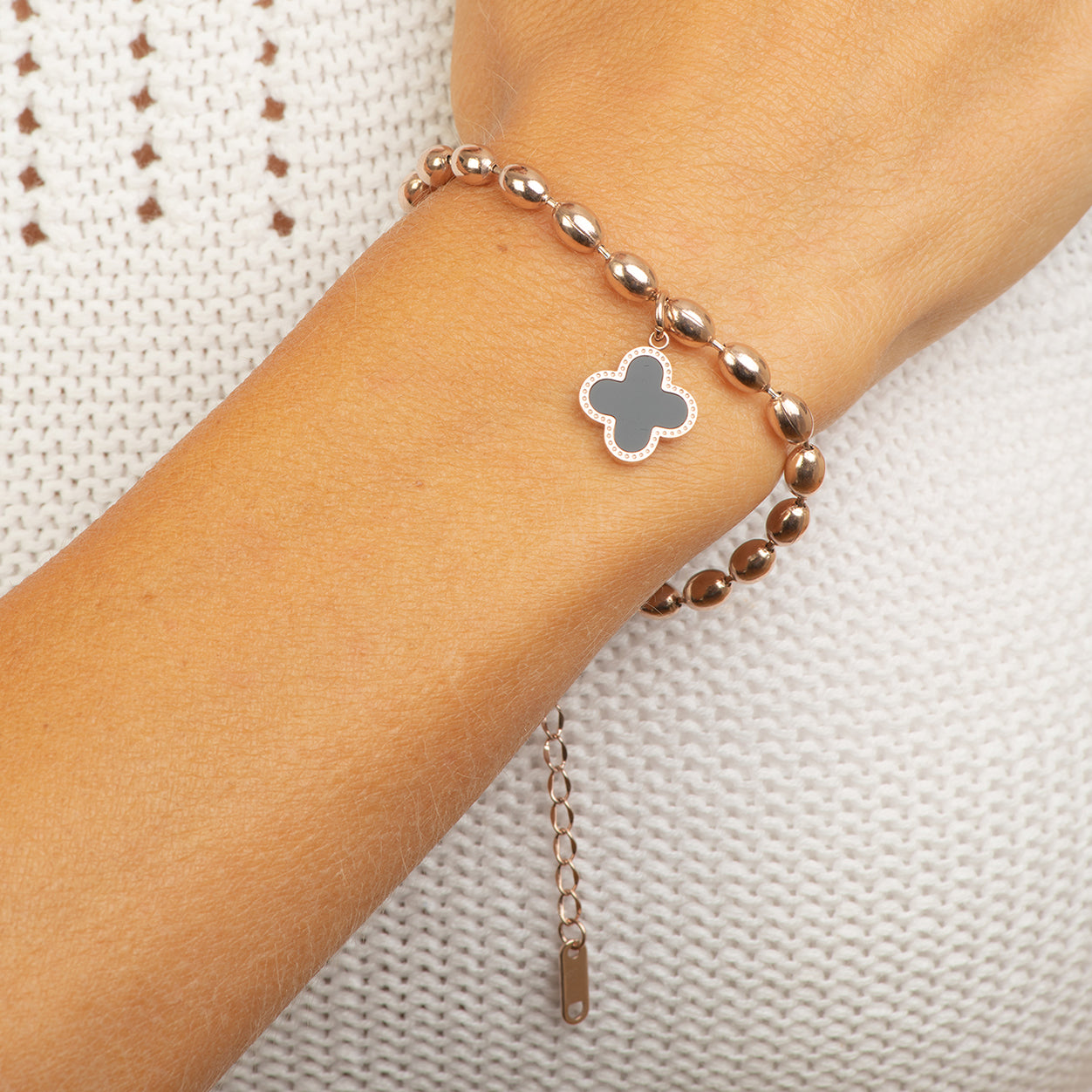 Stainless steel rose gold oval beads with black flower pendent