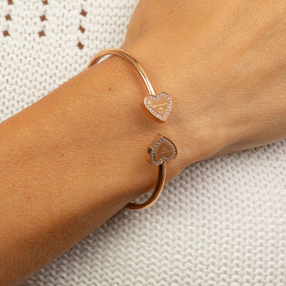 Stainless steel rose gold bangle with 2 hearts